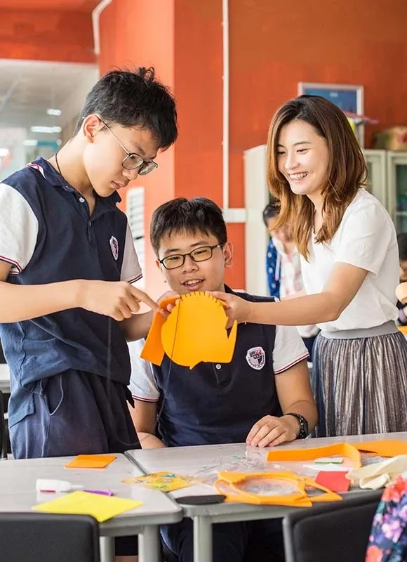 博纳学校艺术课堂中的教师与学生进行手工制作